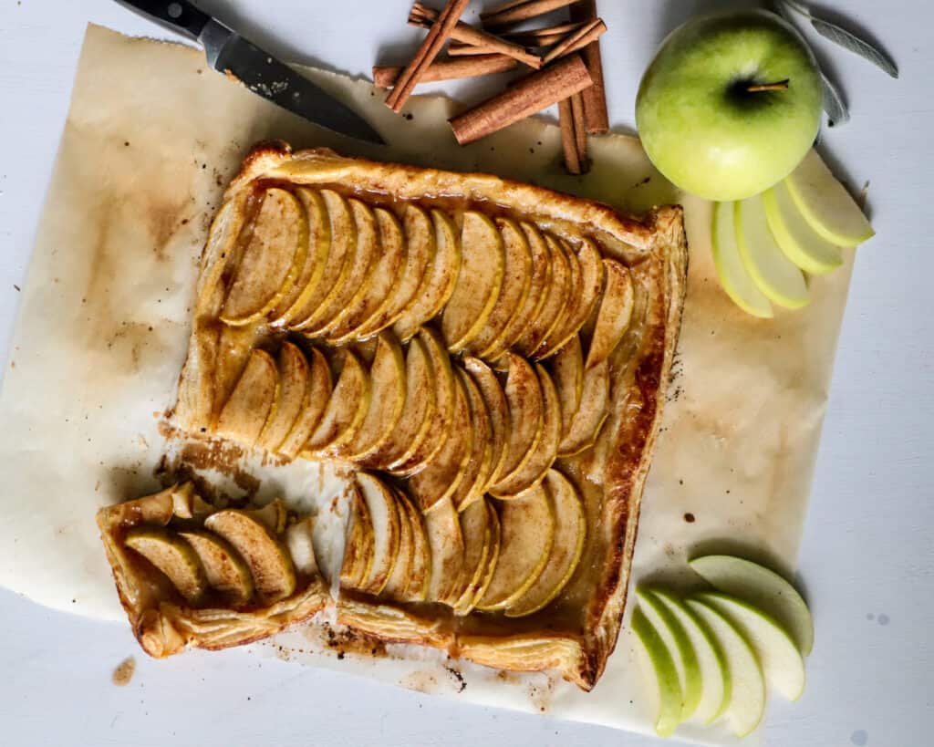 sliced puff pastry apple tart on parchment paper