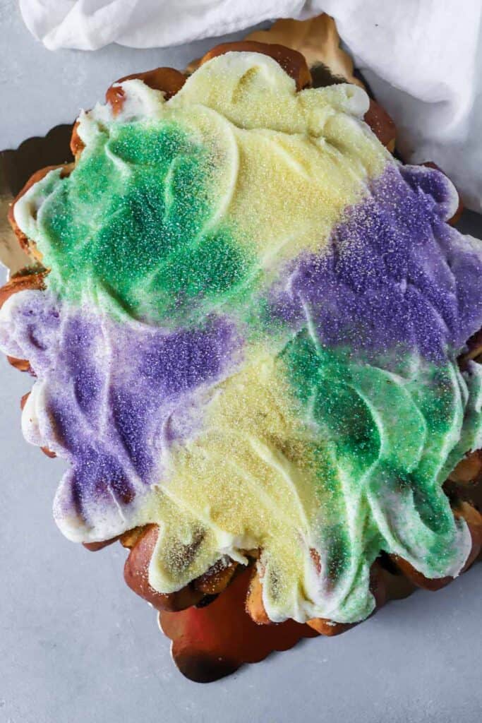 king cake with sprinkles and icing on a counter