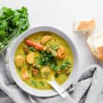 vietnamese chicken curry recipe, Ca Ri Ga, in a bowl with soup spoon and bread on the side