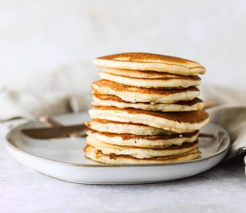 buttermilk pancakes on a plate with maple syrup