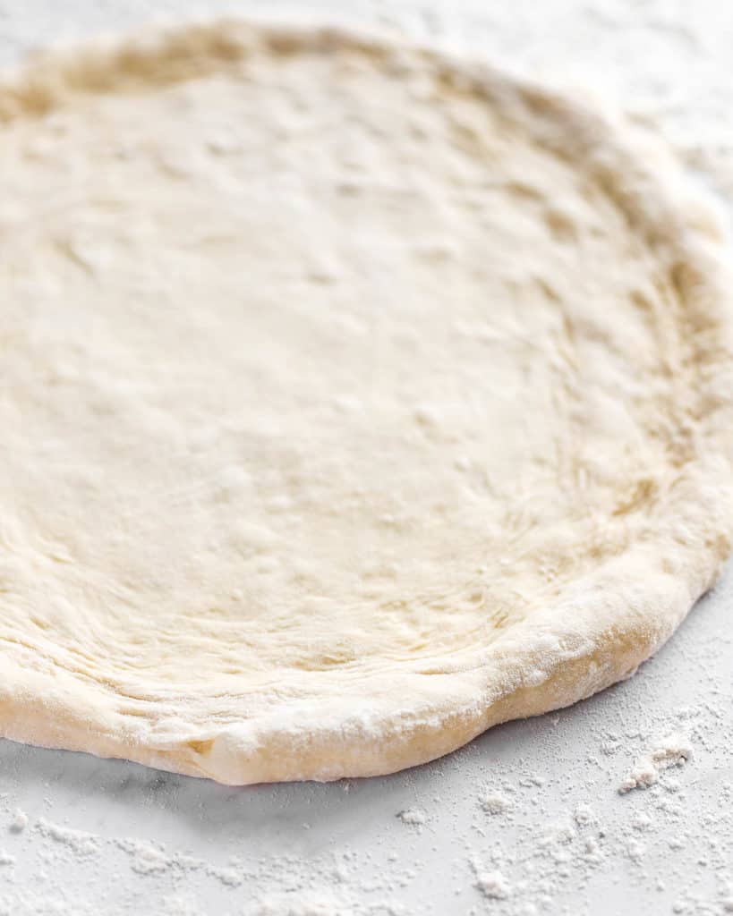 Neapolitan-style Pizza Dough stretched on a counter