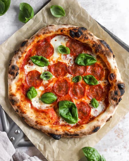 neapolitan-style pizza on a piece of parchment