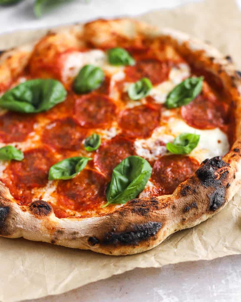 neapolitan-style pizza on a piece of parchment