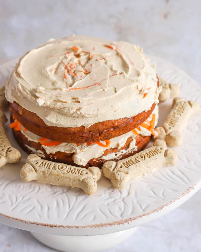 dog carrot cake on a cake stand